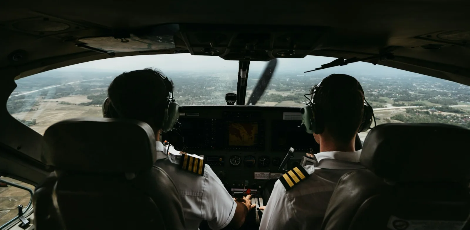 Two pilots flying together in the cockpit of a NextGen training aircraft on a cross-country flight