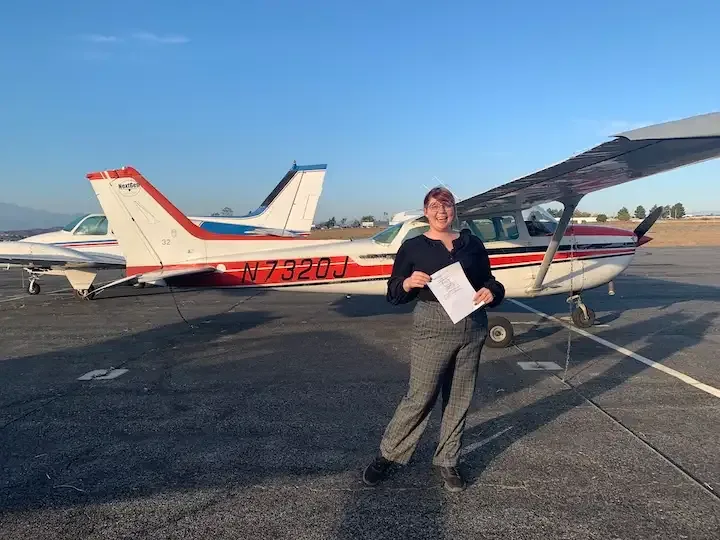 Student pilot celebrating after passing the private pilot checkride in a Cessna 172