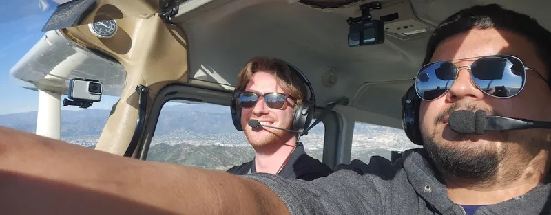 Pilot and passenger during a discovery flight over the Los Angeles basin in a Cessna
